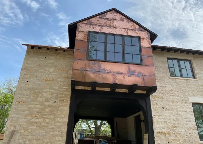 Copper metal panel facade on a stone building for Skylight Installation in Missouri City