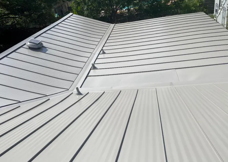 Solar attic fan installed on a metal roof for Roof Ventilation in Missouri City